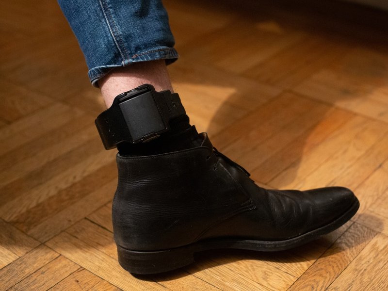 Donziger displays the ankle monitor he is required to wear. Photo: Annie Tritt for The Intercept