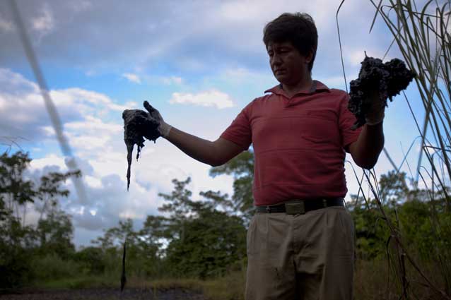 Donald Moncayo demonstrating oil contamination from a Chevron waste pit