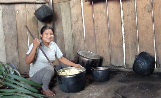 Achuar woman making chicha