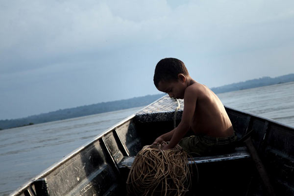 The fisherman's Tatá's grandson learns the wisdom he needs to earn a living early. But his grandfather's knowledge will have little value after the arrival of the dam. Photo credit: Marcio Isensee e Sá