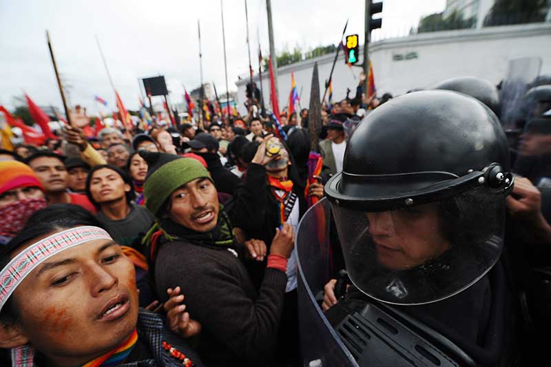Demonstrators struggle with riot police during a march to protest against the policies of President Rafael Correa they say will result in more mining in the Amazon region and threaten the environment and their way of life, on March 22, 2012. Protests were prompted partly by a recent agreement between Ecuador and China for industrial copper mining in the Amazon's Ecuacorriente Zamora-Chinchipe region.The march was organized by the Confederation of Indigenous Nationalities of Ecuador (CONAIE), a powerful umbrella group that represents natives from around the country. Correa accused CONAIE of trying to destabilize his government. Credit: Rodrigo Buendia/AFP/Getty Images