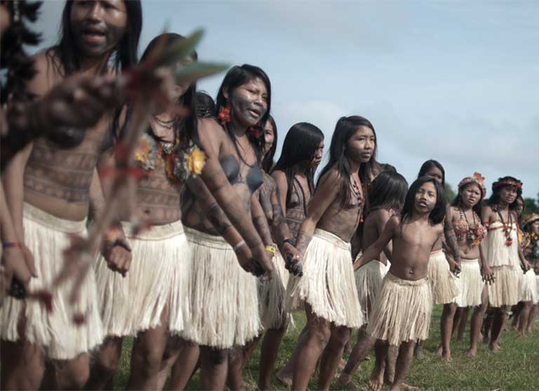 Munduruku women gather in a circle and dance, performing a traditional ritual during a 2013 assembly in Restinga village. The indigenous group has maintained its culture and autonomy despite past attempts by Christian missionaries to ban their language and rites. Group leaders fear that the new dams would do significant cultural and economic harm. Photo credit: Anderson Barbosa of the Anderson Barbosa / Fractures Collective.