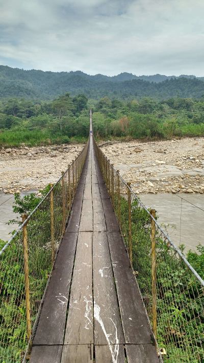 The 450 meter bridge that crosses the Cobaria River is what separates Berito's house on the eastern border of the resguardo and the Catholic mission that once held him against his will. Photo credit: Jake Ling.