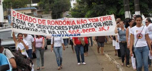 The surge in Porto Velho's population has brought crisis to the city's health care infrastructure. Striking health workers protest on the streets of Porto Velho.